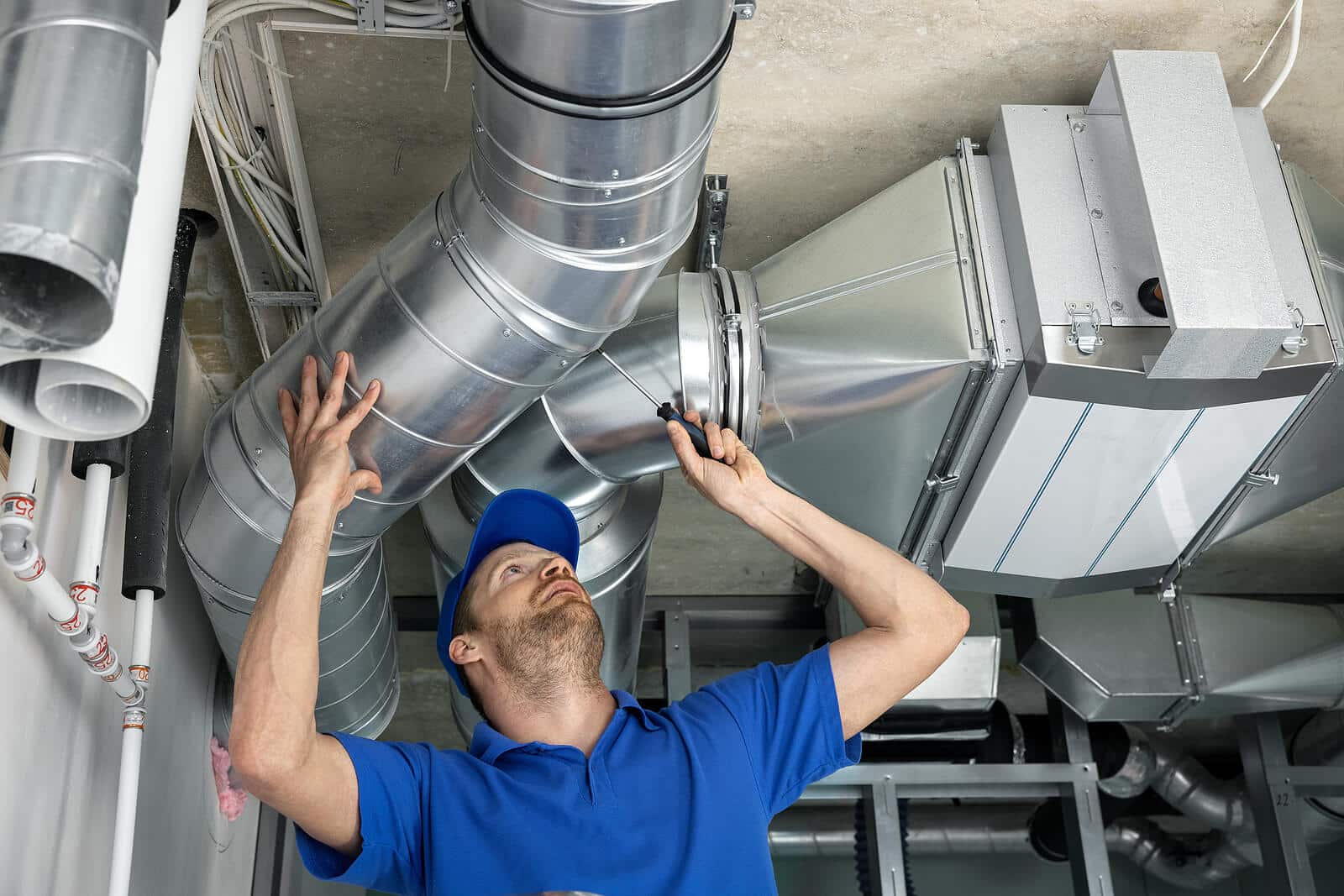 HVAC technician inspecting and repairing air ducts in Saratoga