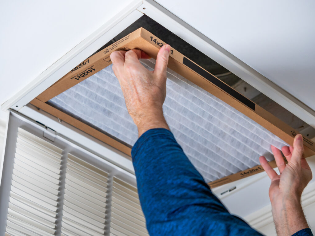 HVAC technician replacing a home air filter in Saratoga