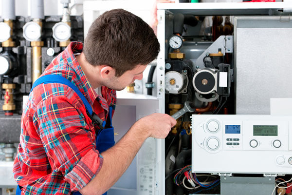 Heating technician repairing boiler controls in Saratoga