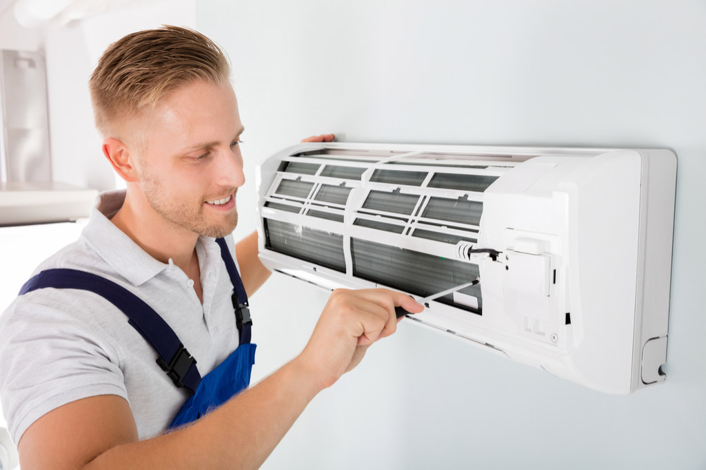 HVAC technician maintaining a ductless air conditioner in Saratoga