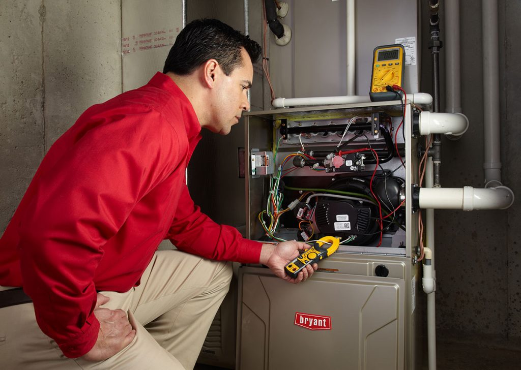 Heating technician diagnosing a furnace repair in Saratoga
