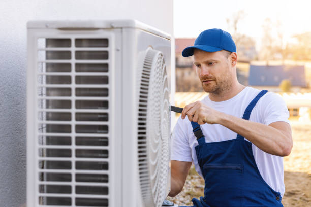 HVAC technician servicing an outdoor air conditioner in Saratoga
