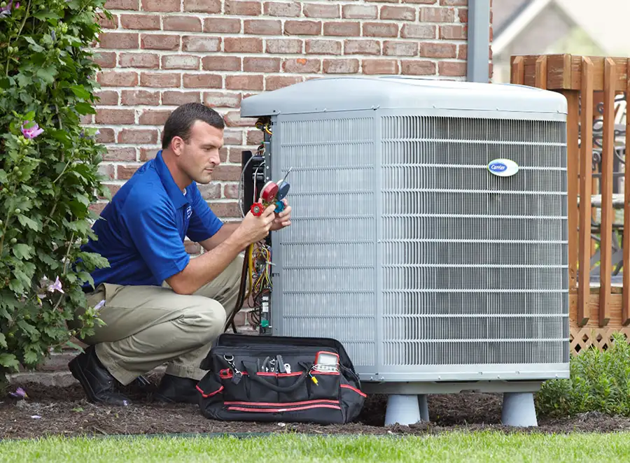HVAC technician inspecting an outdoor AC unit in Saratoga